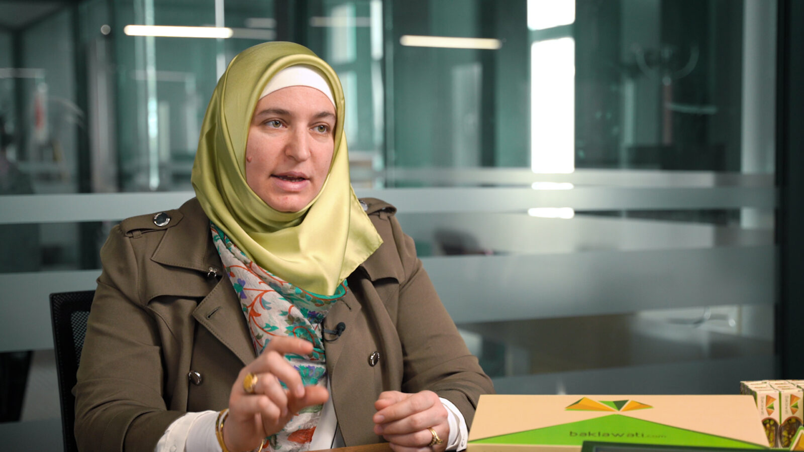 Refugee entrepreneur who has recieved credit score trainings introduces her company.